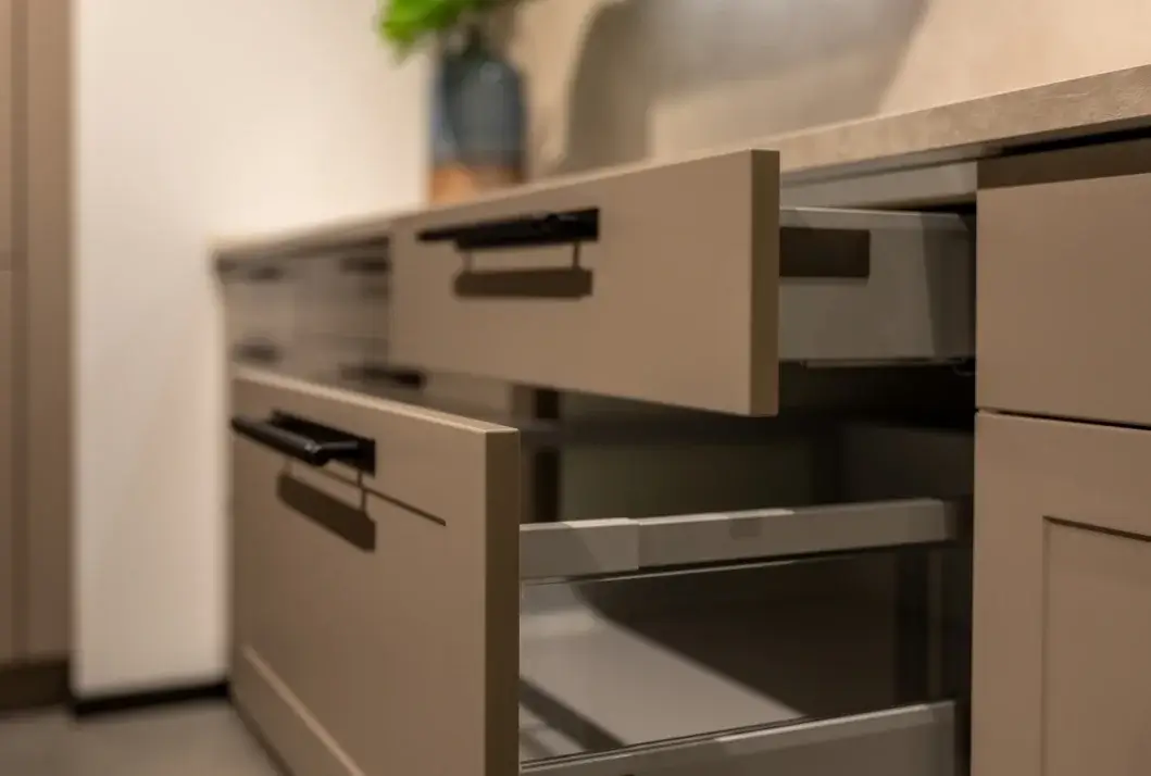 Custom cabinet drawers with soft-close slides and a matte taupe finish